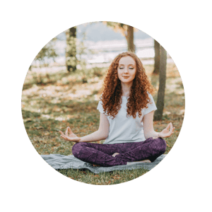 Young woman meditating in Lotus Pose at the park