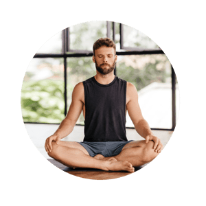 Young men doing yoga lotus pose indoors