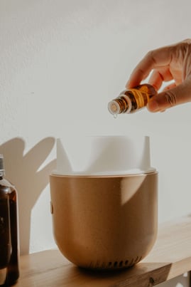 putting an essential oil in a diffuser